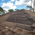 wind damaged house roof with missing asphalt shingles after hurricane ian florida repair home rooftop concept 1 Roof Replacement vs Roof Repair Roof Ready for Spring,roof damage after winter,roof repair warning signs JAR Roofing Repair